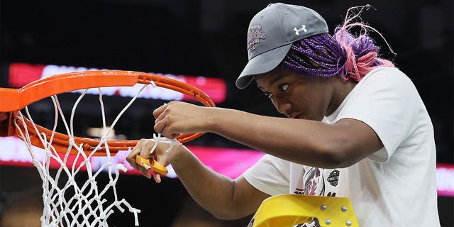 Aliyah Boston of the South Carolina Gamecocks cuts down a piece of the net after defeating the Connecticut Huskies 64-49 in the 2022 NCAA women's basketball national championship game at Target Center April 3, 2022, in Minneapolis.