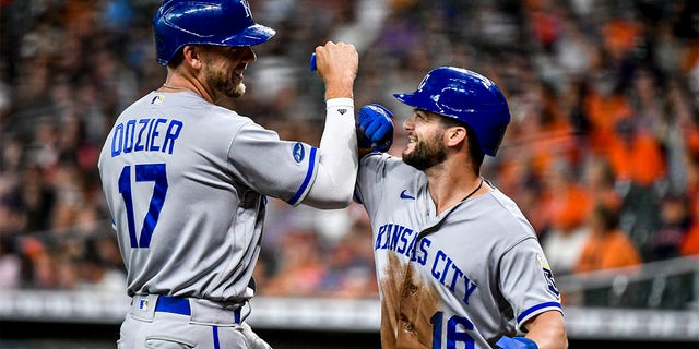 Hunter Dozier #17 of the Kansas City Royals celebrates his two-run home run with Andrew Benintendi #16 against the Houston Astros in the first inning at Minute Maid Park on July 06, 2022 in Houston, Texas. 