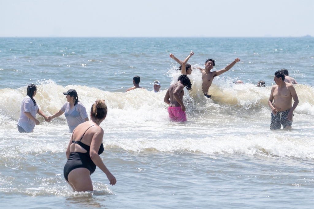 People splash in the waves.