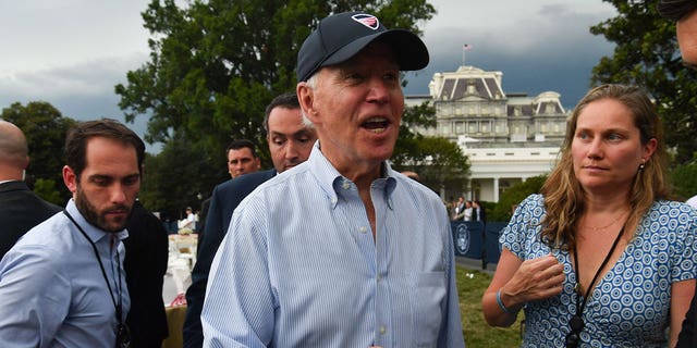 US President Joe Biden, next to Annie Tomasini, Director, Oval Office Operations (R), speaks to reporters during the White House Congressional Picnic on July 12, 2022 in Washington, DC.