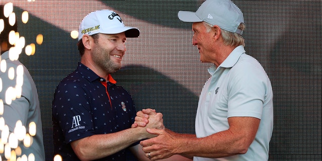 LIV Golf CEO Greg Norman, right, congratulates Branden Grace, winner of the Portland Invitational LIV Golf tournament in North Plains, Ore., Saturday, July 2, 2022. 