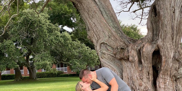 Jared and Kristen Bridegan embrace on a family vacation.