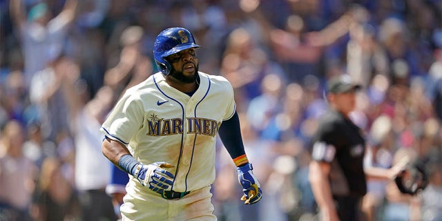 Seattle Mariners' Carlos Santana watches his two-run home run against the Toronto Blue Jays during the eighth inning of a baseball game, Sunday, July 10, 2022, in Seattle. Santana had two home runs and the Mariners won 6-5. 