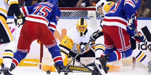 Casey DeSmith #1 of the Pittsburgh Penguins tends net against Ryan Reaves #75 of the New York Rangers in Game One of the First Round of the 2022 Stanley Cup Playoffs at Madison Square Garden on May 03, 2022 in New York City. The Penguins defeated the Rangers 4-3 in triple overtime.  