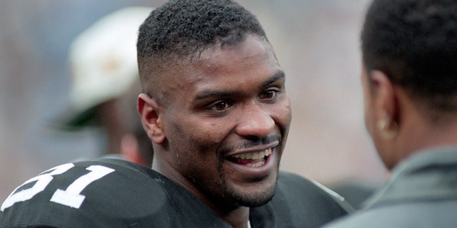 Wide receiver Charles Johnson, #81 of the Pittsburgh Steelers, talks to injured teammate Yancey Thigpen on the sideline during a playoff game against the Indianapolis Colts at Three Rivers Stadium on December 29, 1996 in Pittsburgh, Pennsylvania.  The Steelers defeated the Colts 42-14.