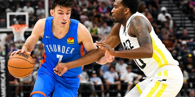 Chet Holmgren #7 of the Oklahoma City Thunder drives into Vic Law #70 of the Utah Jazz during a NBA Summer League game at Vivint Arena on July 05, 2022 in Salt Lake City, Utah.