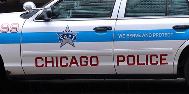 People walk past police car on June 26, 2013 in Chicago.