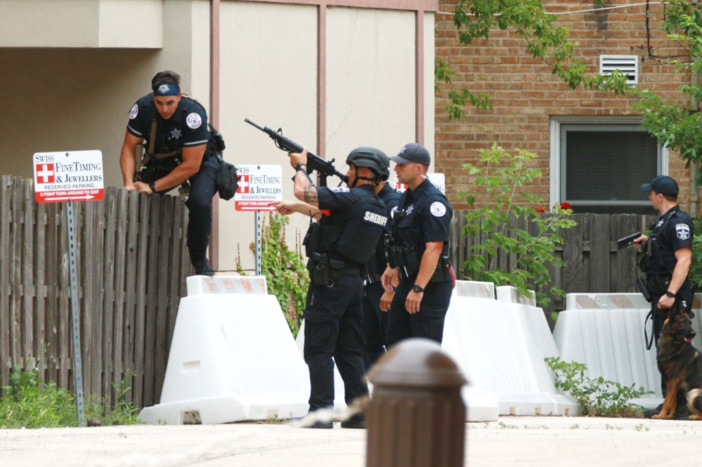 Law enforcement search the area of a shooting at a Fourth of July parade on July 4, 2022 in Highland Park, Illinois. 