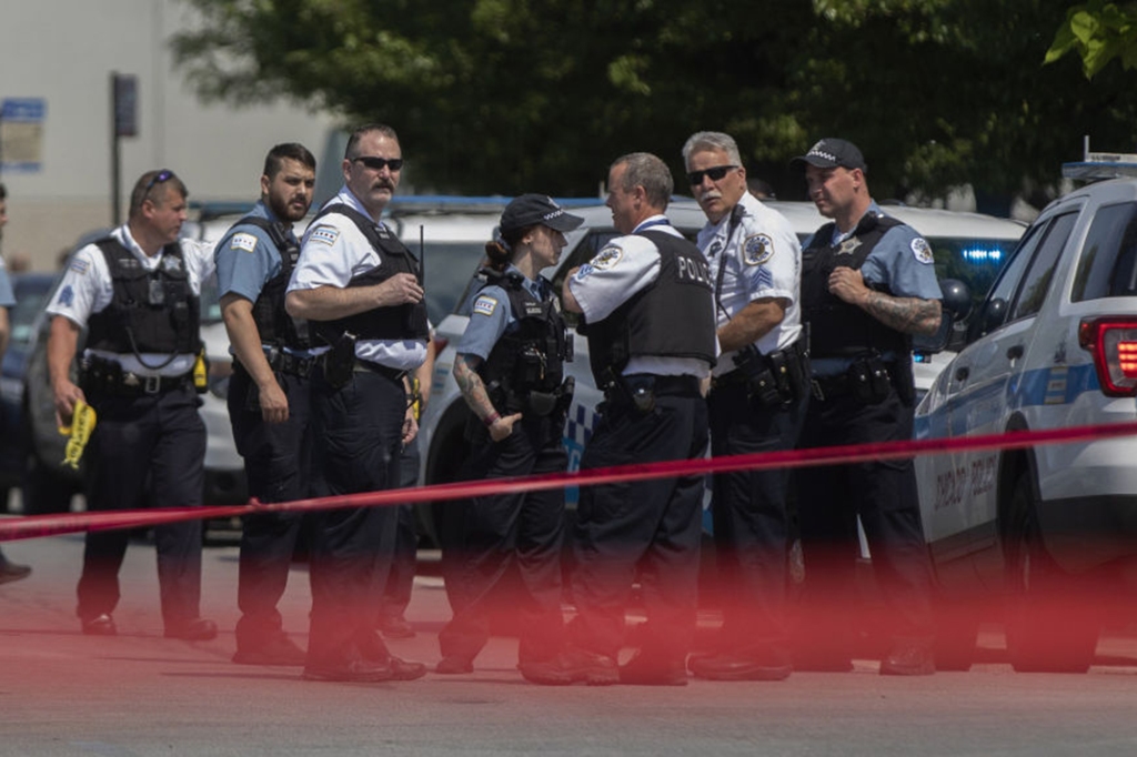 Chicago police officers work at the scene where a Chicago officer was shot and wounded on June 5, 2022.