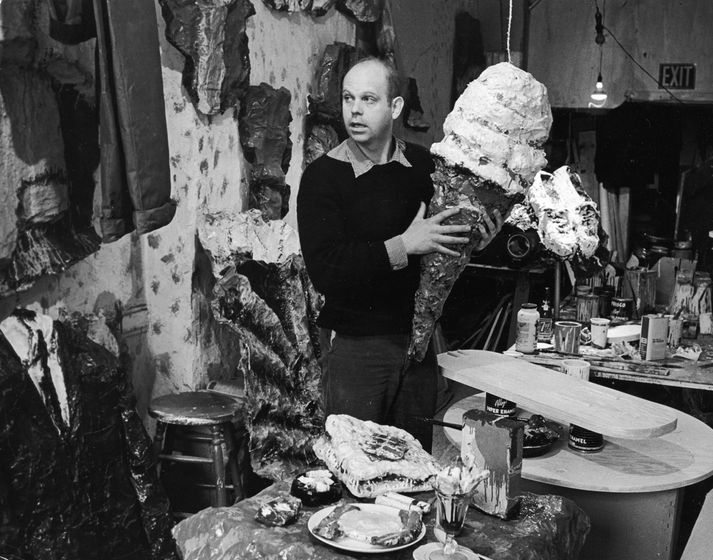 Claes Oldenburg holds one of his pieces, a four-foot ice cream cone, at his studio in Greenwich Village in NYC circa 1965.