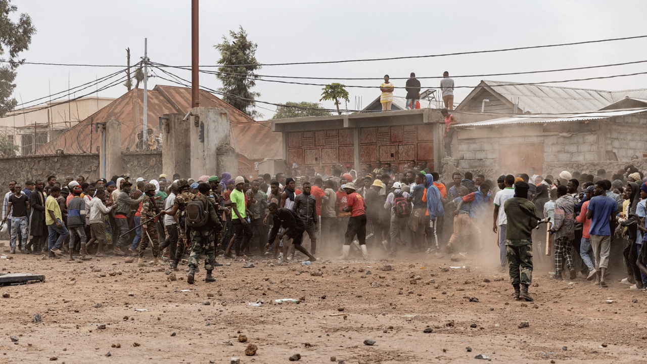 Soldiers of the Democratic Republic of Congo’s armed forces try to control a crowd of protesters storming a base of the UN peacekeeping operation MONUSCO, in Goma, on July 26, 2022. - A demonstrator was shot dead on July 26 on the second day of anti-UN protests in the eastern DR Congo city of Goma, an AFP journalist saw. Demonstrations against the perceived ineffectiveness of the UN peacekeeping operation MONUSCO erupted on July 25, and turned violent when protesters stormed the mission’s local headquarters and a logistical base. 