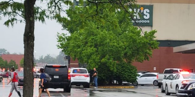 Police gather outside a Dick's Sporting Goods.