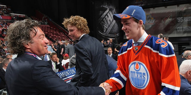 Connor McDavid greets owner Daryl Katz after being selected first overall by the Edmonton Oilers during Round One of the 2015 NHL Draft at BB&amp;T Center on June 26, 2015 in Sunrise, Florida. 