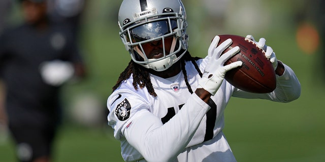 The Las Vegas Raiders' Davante Adams catches a pass during training camp Friday, July 22, 2022, in Henderson, Nev.