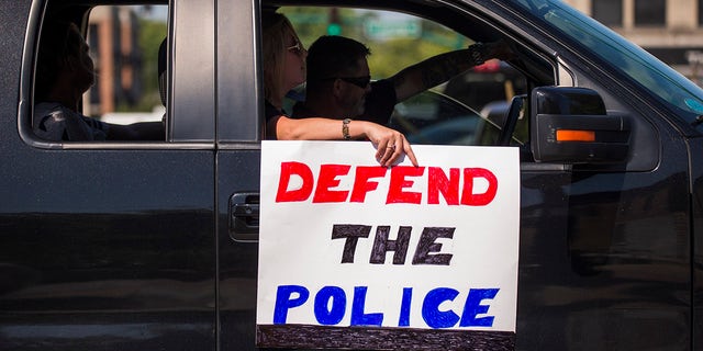 Protesters pass through downtown Bloomington, Indiana, during a "Defend the Police" event.