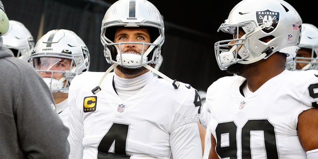 Las Vegas Raiders quarterback Derek Carr (4) looks toward fans before a wild-card game against the Cincinnati Bengals Jan. 15, 2022, at Paul Brown Stadium in Cincinnati.