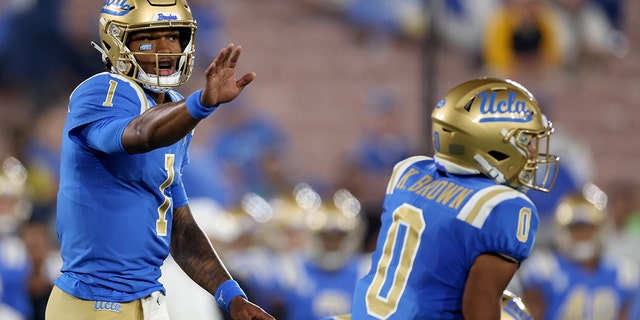 Dorian Thompson-Robinson #1 of the UCLA Bruins calls a play to Kam Brown #0 during the first half against the Arizona State Sun Devils at Rose Bowl on October 02, 2021 in Pasadena, California.