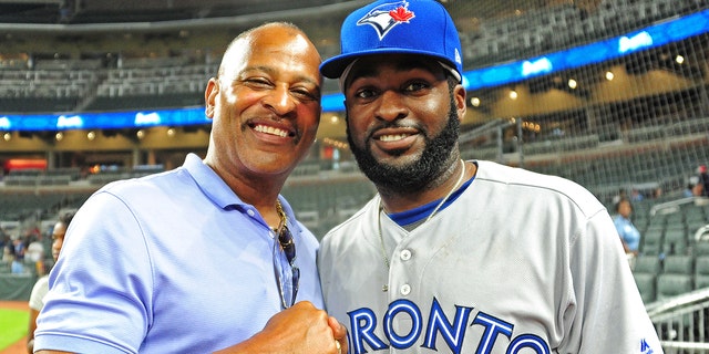 Former MLB player Dwight Smith, left, poses for a photograph with his son, Dwight Smith Jr. of the Toronto Blue Jays, at a game at SunTrust Park on May 18, 2017, in Atlanta.