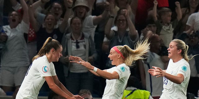 England's Ella Toone, left, celebrates with teammates after scoring her side's first goal during the Women Euro 2022 quarter final soccer match between England and Spain at the Falmer stadium in Brighton, Wednesday, July 20, 2022. 