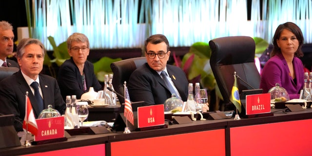 From left to right, U.S. State Secretary Antony Blinken, Brazilian Foreign Minister Carlos Franca, attend the opening session of the G-20 Foreign Ministers' Meeting in Nusa Dua, Bali, Indonesia, Friday, July 8, 2022. (AP Photo/Dita Alangkara, Pool)