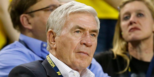 Former Michigan football coach Gary Moeller watches the second half of an exhibition NCAA college basketball game against Wayne State in Ann Arbor, Mich., Nov. 4, 2013. Former Michigan, Illinois and Detroit Lions coach Moeller died Monday, July 11, 2022. He was 81. The University of Michigan announced his death, and no cause was provided. 