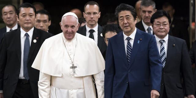 Pope Francis walks with Japan's Prime Minister Shinzo Abe as he arrives for their meeting at the prime minister's official residence in Tokyo Nov. 25, 2019. 