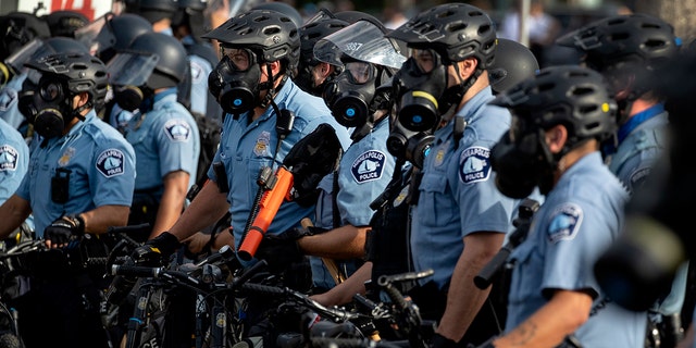 Minneapolis Police officers lined up as demonstrators protested the killing of George Floyd outside the Minneapolis Police Department's Third Precinct office in south Minneapolis. 