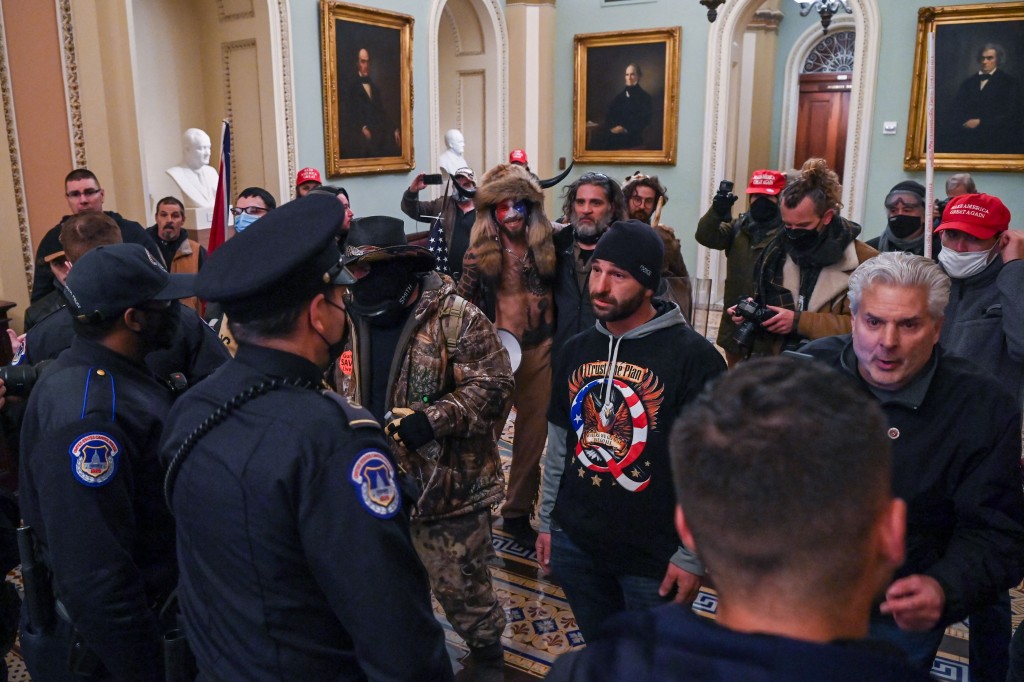 Protesters face off with US Capitol police officers, as cops try to stop them from invading the Capitol on January 6, 2021.