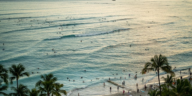 HONOLULU, HI - JUNE 26: The sun sets off of Waikiki Beach on the Hawaiian island of Oahu on Saturday, June 26, 2021 in Honolulu, HI. (Kent Nishimura / Los Angeles Times via Getty Images)