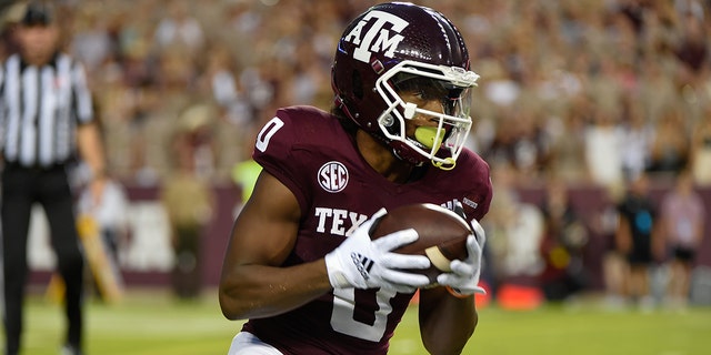 Texas A&amp;M Aggies wide receiver Ainias Smith (0) fields an early first quarter punt then returns it over 90 yards for a touchdown during the game between the South Carolina Gamecocks and the Texas A&amp;M Aggies at Kyle Field on Oct. 23, 2021 in College Station, Texas. 