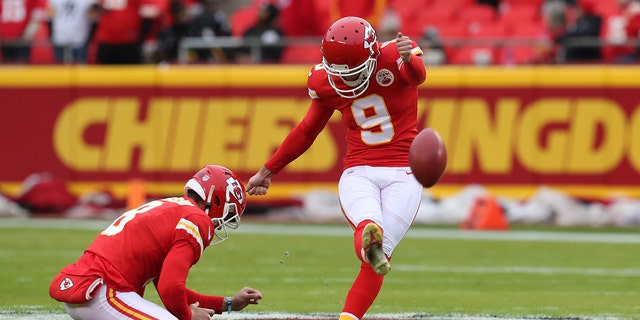 Kansas City Chiefs kicker Elliot Fry (9) kicks from the hold of punter Johnny Townsend (8) before a game against the Pittsburgh Steelers Dec 26, 2021, at GEHA Field at Arrowhead Stadium in Kansas City, Mo. 