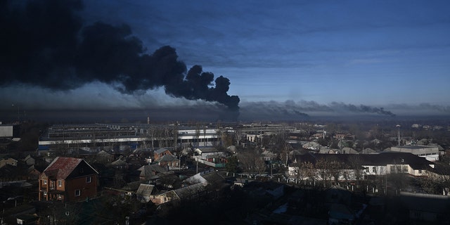 Black smoke rises from a military airport in Chuguyev near Kharkiv  on February 24, 2022.