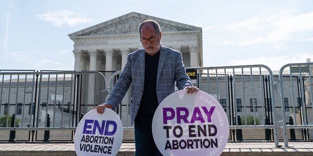 An anti-abortion demonstrator prays near the U.S. Supreme Court in Washington on June 8, 2022.