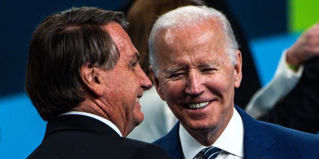 TOPSHOT - Brazil's President Jair Bolsonaro (L) and U.S. President Joe Biden chat after posing for a family photo during the 9th Summit of the Americas in Los Angeles, California, June 10, 2022. (Photo by Chandan KHANNA / AFP) (Photo by CHANDAN KHANNA/AFP via Getty Images)