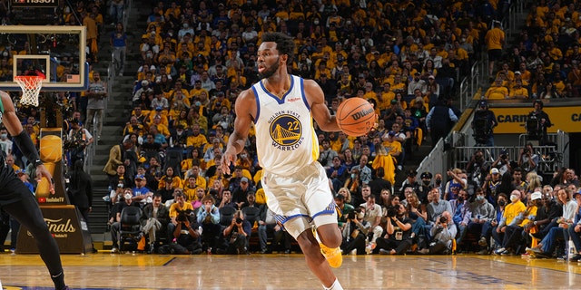 Golden State Warriors' Andrew Wiggins dribbles the ball against the Boston Celtics during Game Five of the 2022 NBA Finals on June 13, 2022 at Chase Center in San Francisco, California.