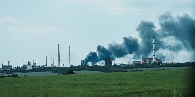 A column of smoke rises from an industrial area outside of  Lysychansk, Ukraine, Monday June 13, 2022. (Marcus Yam / Los Angeles Times via Getty Images)