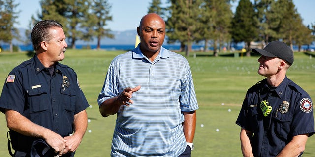 Sports analyst Charles Barkley talks to the Tahoe Douglas Fire Department about their efforts before teeing off Round Two of the 2022 American Century Championship at Edgewood Tahoe Golf Course in Stateline, Nev., on July 9, 2022.