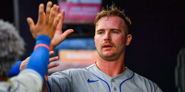 New York first baseman Pete Alonso (20) gets high-fives in the dugout during the MLB game between the New York Mets and the Atlanta Braves on July 11th, 2022, at Truist Park in Atlanta, GA.