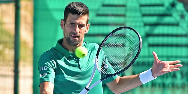 Serbian tennis player Novak Djokovic returns the ball during an exhibition match in Visoko, Bosnia and Herzegovina, July 13, 2022. 