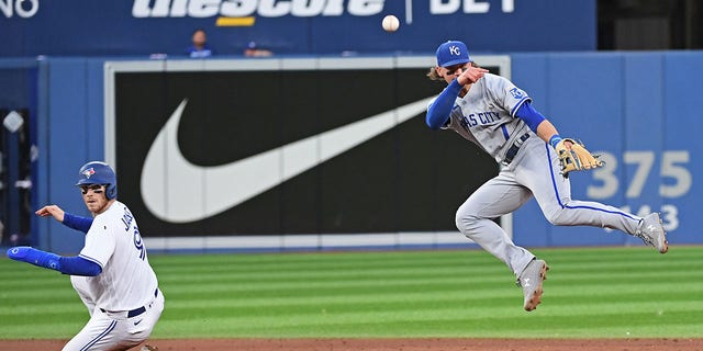 Kansas City Royals Short Stop Bobby Witt Jr (7) attempts to complete a double play in the fifth inning as Toronto Blue Jays Catcher Danny Jansen (9) slides into second base during the regular season MLB game between the Kansas City Royals and Toronto Blue Jays on July 14, 2022 at Rogers Centre in Toronto, ON. 