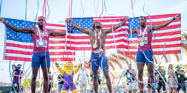 Erriyon Knighton (R), bronze winner, Noah Lyles (M), gold winner, and Kenneth Bednarek, silver medalist, from the USA cheer after the race July 21, 2022 in Eugene, Oregon. 