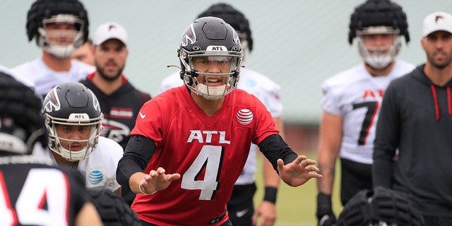 Atlanta Falcons quarterback Desmond Ridder (4) barks out a play call during Saturday morning workouts July, 30, 2022, in Flowery Branch, Ga.  