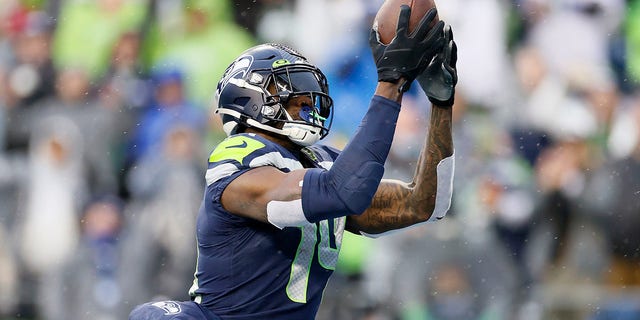 DK Metcalf of the Seattle Seahawks catches a pass for a touchdown against the Detroit Lions during the first half of their NFL game at Lumen Field in Seattle, Washington, on Jan. 2, 2022.