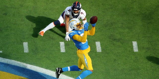 Derwin James of the Los Angeles Chargers stops the pass intended for Kendall Hinton of the Denver Broncos at SoFi Stadium on Jan. 2, 2022, in Inglewood, California. 