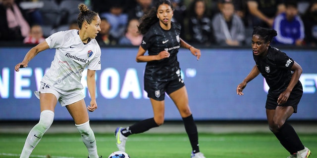 Jaelene Daniels of the North Carolina Courage, left, looks to pass the ball against Angel City FC at Banc of California Stadium April 29, 2022, in Los Angeles. 