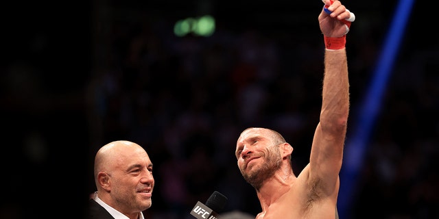 Donald Cerrone (R) speaks with Joe Rogan as he announces his retirement after his welterweight bout against Jim Miller during UFC 276 at T-Mobile Arena on July 02, 2022 in Las Vegas, Nevada. (Photo by Carmen Mandato/Getty Images)