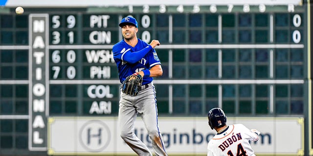 Whit Merrifield #15 of the Kansas City Royals turns a double play against the Houston Astros at Minute Maid Park on July 07, 2022 in Houston, Texas. 