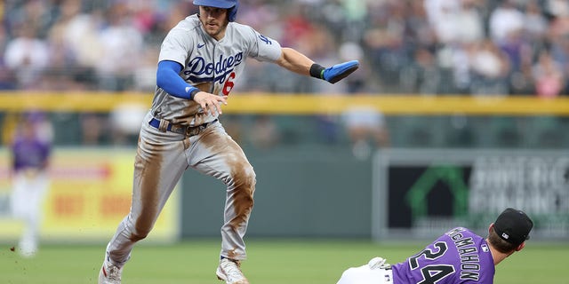 Trea Turner, #6 of the Los Angeles Dodgers, scores on a fielding error against the Colorado Rockies in the first inning at Coors Field on July 28, 2022 in Denver, Colorado. 