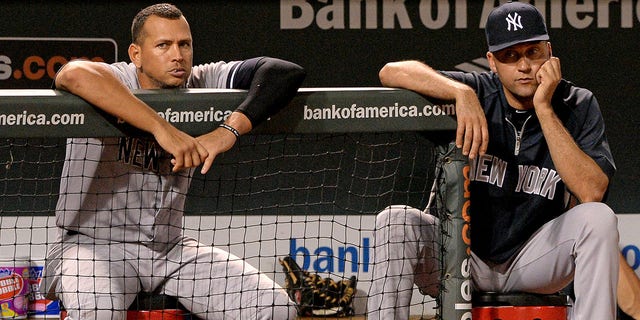 Alex Rodriguez #13 (L) and Derek Jeter #2 of the New York Yankees look on against the Baltimore Orioles in the ninth inning at Oriole Park at Camden Yards on September 11, 2013 in Baltimore, Maryland.