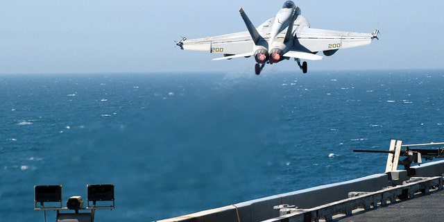 FILE- An F/A-18E Super Hornet launches from one of four steam powered catapults on the flight deck aboard USS Abraham Lincoln.